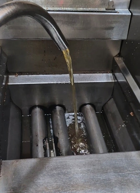 Clean filtered oil being returned to the fryer with The BOSS